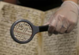 A detail of a fragment of a Koran manuscript is seen through a magnifying glass in the library at the University of Birmingham in Britain July 22, 2015. A British university said on Wednesday that fragments of a Koran manuscript found in its library were from one of the oldest surviving copies of the Islamic text in the world, possibly written by someone who might have known Prophet Mohammad. Radiocarbon dating indicated that the parchment folios held by the University of Birmingham in central England were at least 1,370 years old, which would make them one of the earliest written forms of the Islamic holy book in existence.  REUTERS/Peter Nicholls